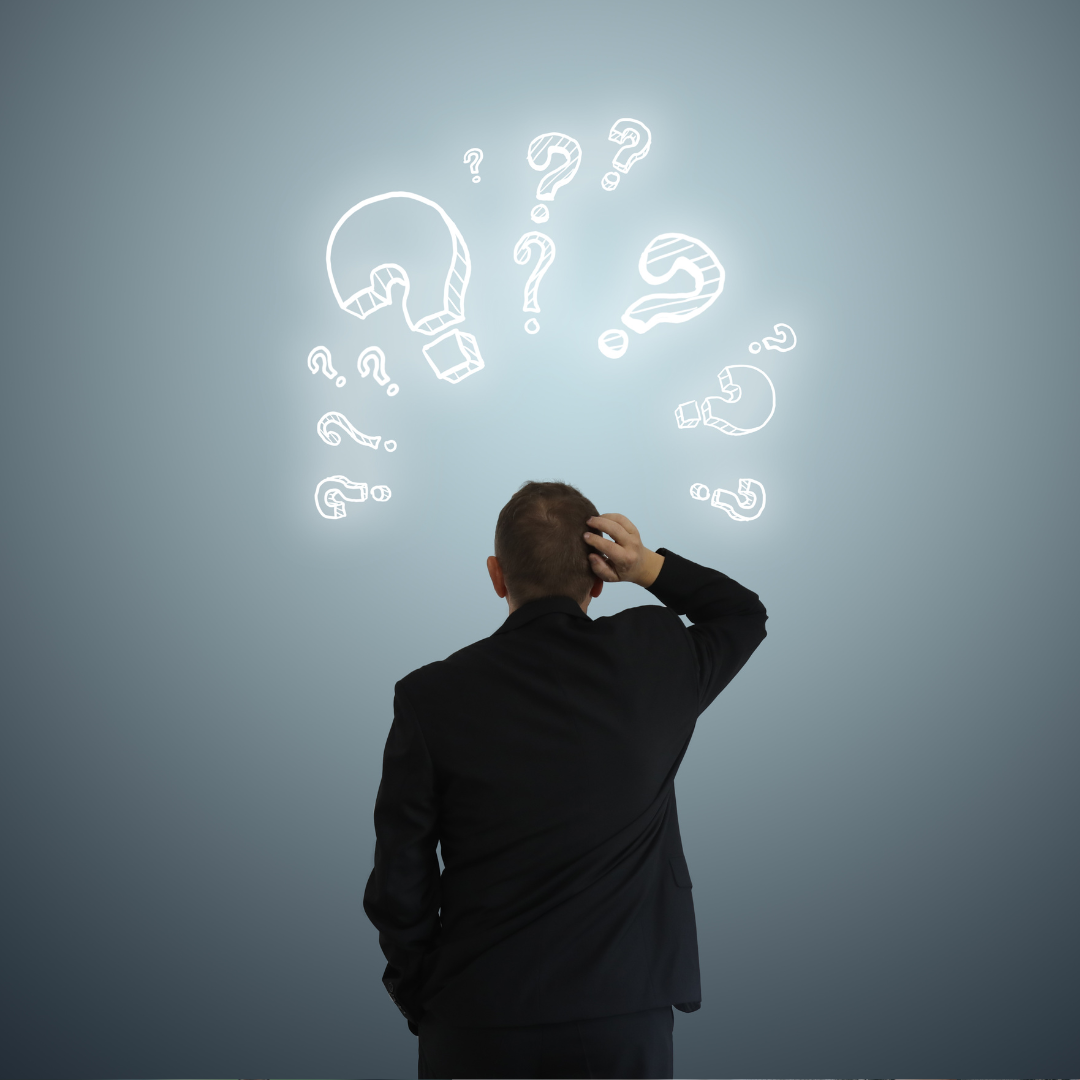 A man sitting at a table with a laptop and paperwork, with a woman in a suit handing him a file, with a city and trees in the background, Worrells.