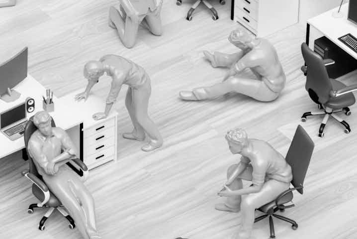 Frustrated plastic blue figurines in various poses in an office
